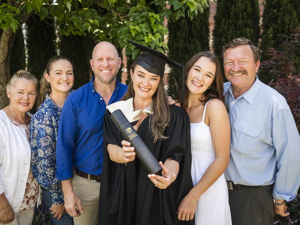 Master of Arts graduate Sarah Green with family (from left) Jenny Balderson, Bethany Burima, Kristin Green, Sienna Green and Wayne Balderson at a UniSQ graduation ceremony at Empire Theatres, Tuesday, October 31, 2023. Picture: Kevin Farmer