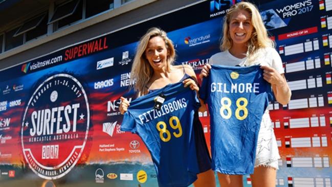 Sally Fitzgibbons and Steph Gilmore holding their WSL CT jerseys at Merewether Beach, Newcastle