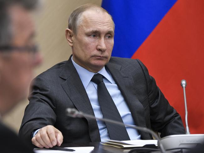 Russian President Vladimir Putin listens during a cabinet meeting at the Novo-Ogaryovo residence outside Moscow, Russia, Wednesday, April 18, 2018. (Alexei Nikolsky, Sputnik, Kremlin Pool Photo via AP)