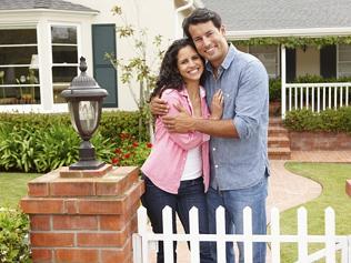 Hispanic couple outside home