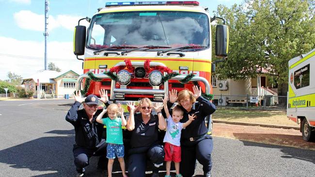 TOY RUN: Firefighters Russell Schwerin, Cheryl Schwerin and Sandran Hayward with Tyasha and Blayze Bullock doing their best reindeer impressions. Picture: Shannon Hardy