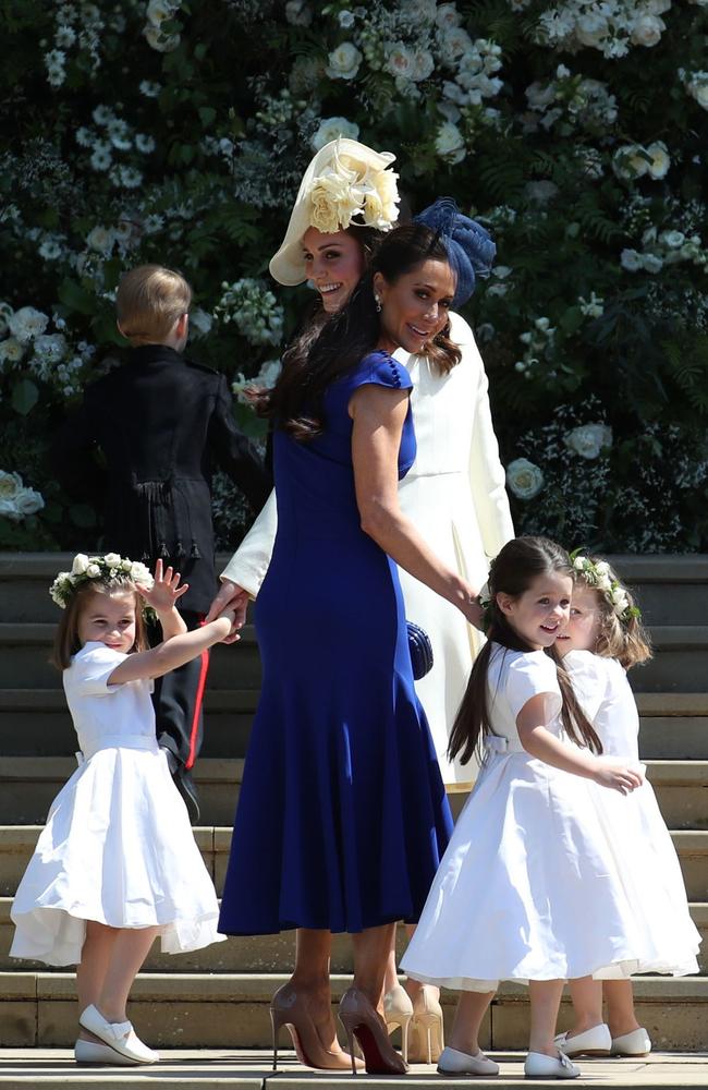Britain's Catherine, Duchess of Cambridge (L) and Meghan Markle's friend, Canadian fashion stylist Jessica Mulroney hold bridesmaids hands as they arrive for the wedding ceremony. Picture: AFP PHOTO / POOL / Jane Barlow