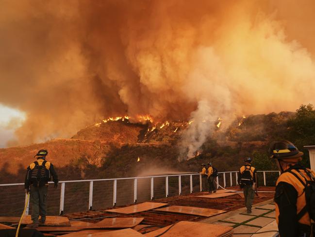 Fire crews monitor the Palisades Fire in Mandeville Canyon on Saturday, Jan. 11, 2025, in Los Angeles. (AP Photo/Jae C. Hong)