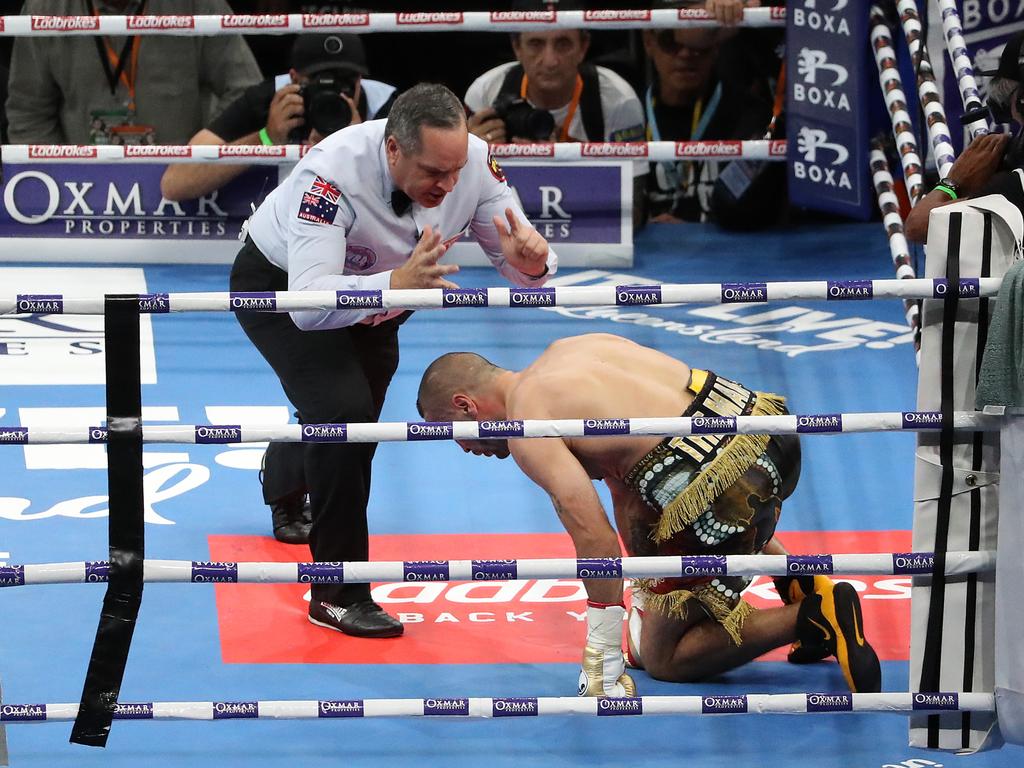 The referee counts out Mundine. Picture: Peter Wallis