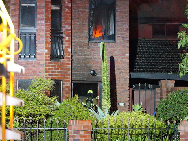 A firefighter makes his way through the front entrance. Picture: Patrick Herve