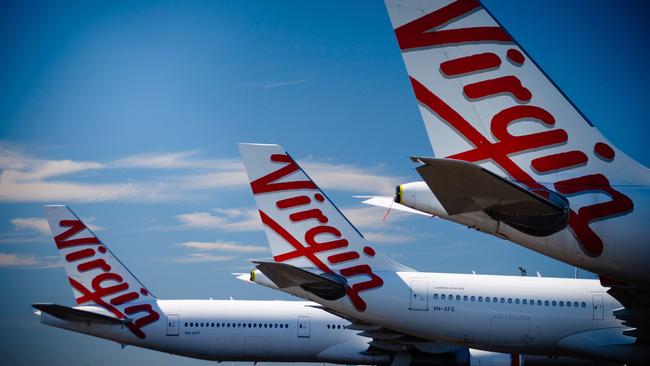 Virgin Australia aircraft are seen parked on the tarmac at Brisbane International airport in April. Picture: AFP