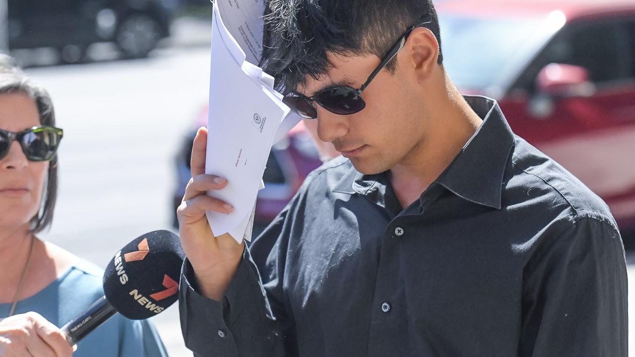 Jonty Akari, 19, is seen leaving Adelaide Magistrates Court, where he has been charged with being unlawfully on premises.