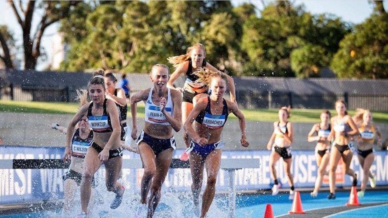 Toowoomba steeplechase athlete Brielle Erbacher (right) negotiates a water obstacle.