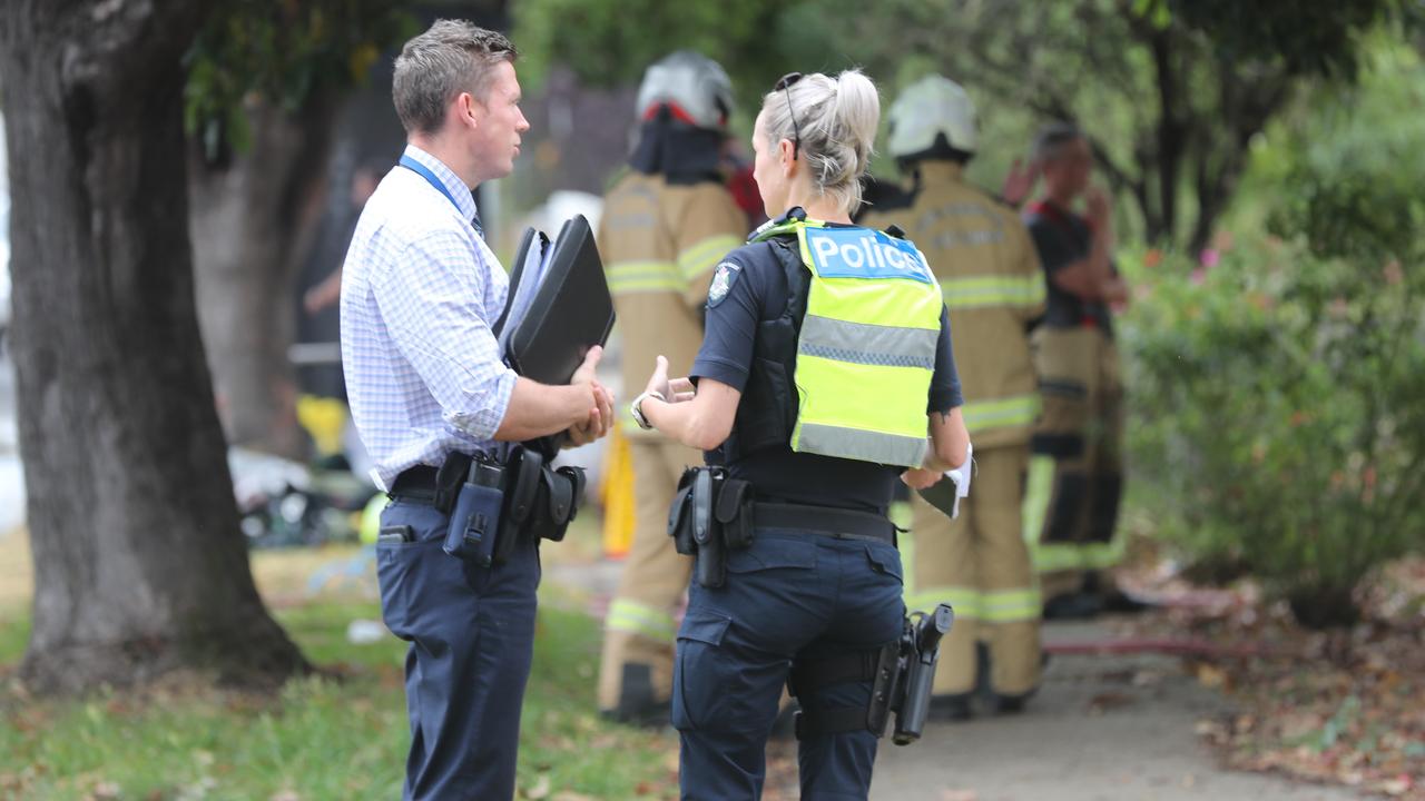 Fire fighters and police on the scene of a house fire on Station Road, North Shore. Picture: Alan Barber