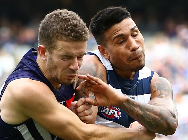 Tim Kelly of the Cats kicks forward under pressure from Sam Switkowski and Nat Fyfe of the Dockers during the Round 20 AFL match between the Fremantle Dockers and the Geelong Cats at Optus Stadium in Perth, Saturday, August 3, 2019.  (AAP Image/Gary Day) NO ARCHIVING, EDITORIAL USE ONLY