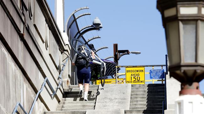 The cycleway over the Sydney Harbour Bridge is currently accessible at the northern end only by a staircase with a concrete ramp through the middle. Picture: Jonathan Ng