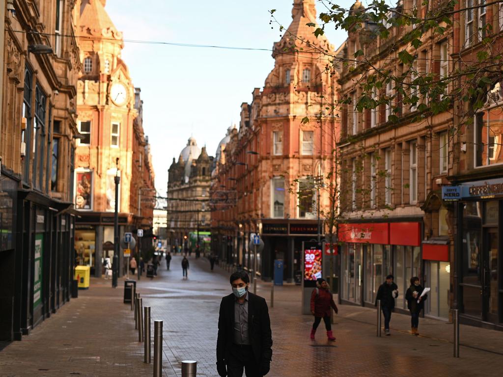 Pedestrians walk past shuttered shops in Leeds, northern England on January 6. Picture: Oli Scarff / AFP