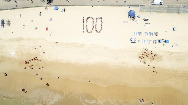 Staff and volunteers from the Royal Far West children's charity at Manly celebrate its 100th anniversary – December 6, 2024 – on Manly Beach