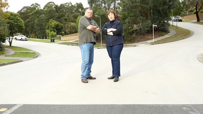 Deep Creek Drive residents Clarke Stevenson and Leanne White are unhappy with the sudden white resurfacing of their street. Picture: Hamish Blair