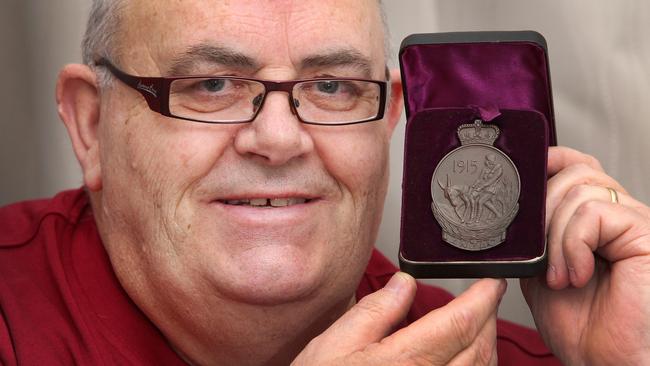 Barry Saltmarsh holds his grandfather’s (Harold Guy Keid) 1915 ANZAC medal.