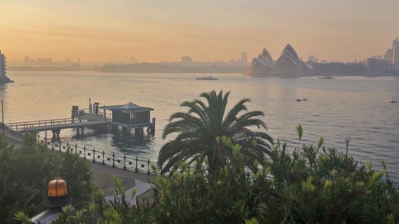 A thick haze over Sydney Harbour on Tuesday. Picture: Fiona Wingett