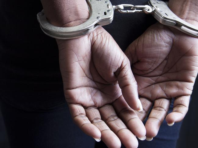 Black woman in handcuffs stock image