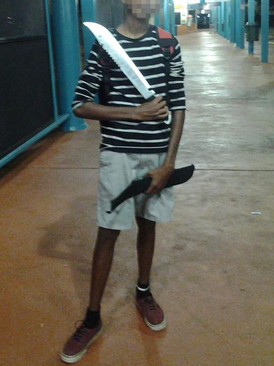 A teen poses with a machete at Palmerston Bus Interchange. Picture: Facebook