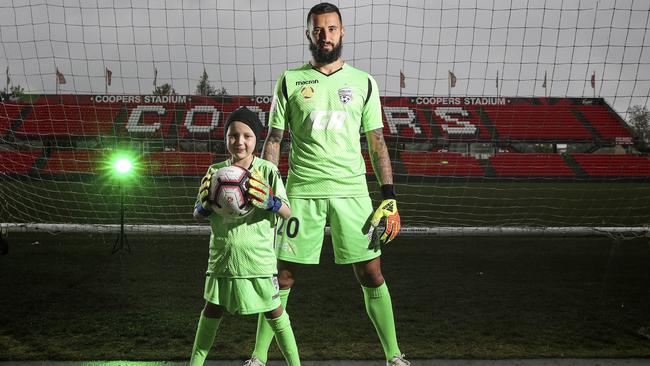 Adelaide United goalkeeper Paul Izzo has built a close bond with Reds fanatic and leukaemia patient Ace Kounavis. Picture: Sarah Reed