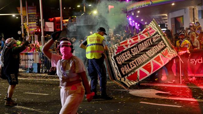 Police could be seen wrestling a protester carrying the sign. Picture: NCA NewsWire / Jeremy Piper