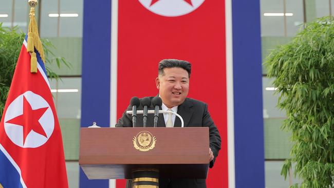 North Korean leader Kim Jong-un may be smiling, but his country’s table tennis champs could be penalised for “grinning” with competitors at the Olympics. Picture: KCNA VIA KNS / AFP