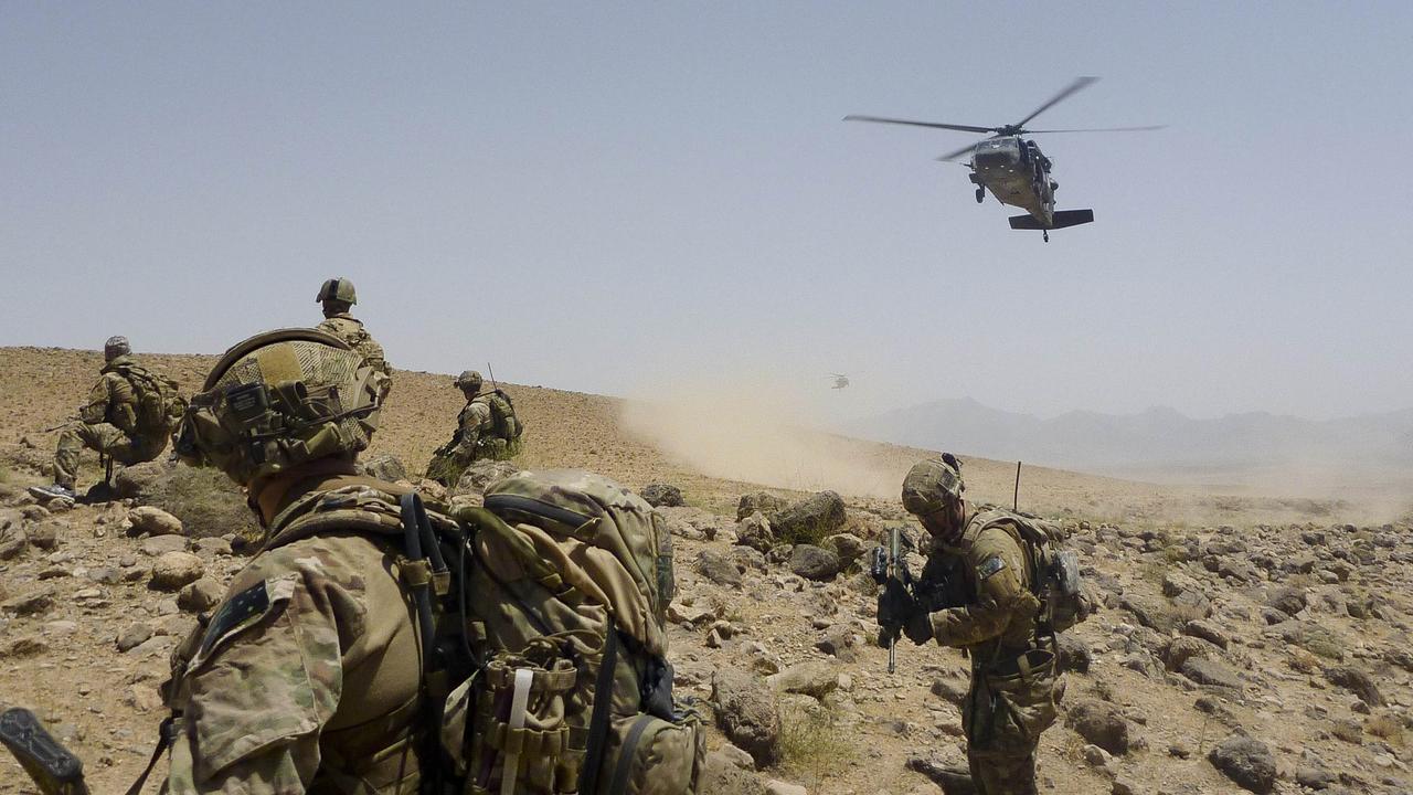 Australian Army soldiers from Special Operations Task Group prepare to be extracted by a US Army Black Hawk helicopter alongside their Afghan National Security Force partners after completing the clearance of a cave system in Uruzgan province, southern Afghanistan, in 2012. Picture: Defence