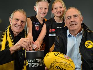 Glenelg Football Club legend Peter Carey, fans Joe Chigwidden (11) & Summer Ryan (12), with club president Nick Chigwidden at the launch of the club's 'Save the Tigers' fund. Pictured at Phil Hoffman travel, Glenelg.picture: Bianca De Marchi