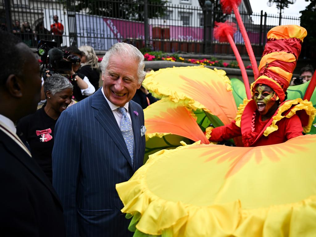 Prince Charles with a performer during a visit to the Commonwealth Games 'Festival Site' at Victoria Square. Picture: Ben Stansall – Pool/Getty Images