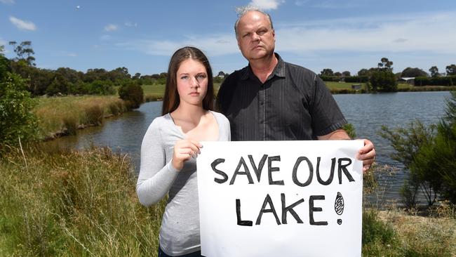 Ferntree Gully's Mark Glazebrook and daughter Taya are worried about the future of a lake on vacant land on Burwood Highway, Knoxfield, which could be under threat from development. Picture: Kylie Else