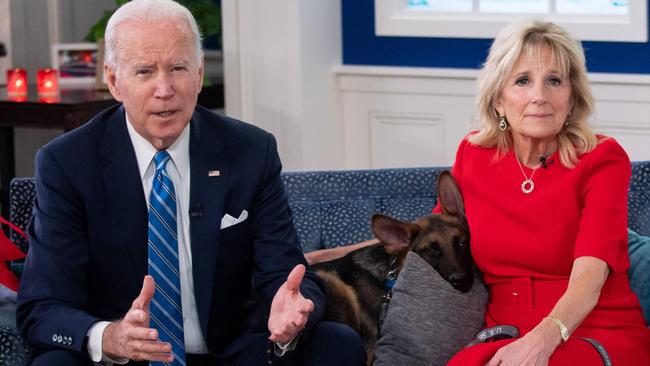 US President Joe Biden and US First Lady Jill Biden, with their dog Commander sharing a sofa. Picture: Saul Loeb/AFP