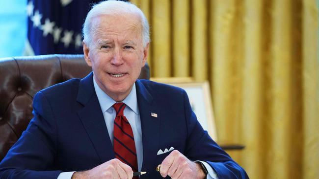 Joe Biden prepares to sign executive orders on affordable healthcare in the Oval Office. Picture: AFP.