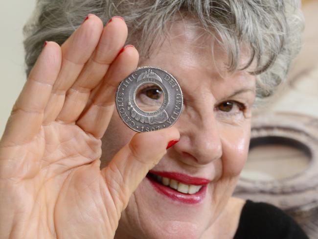 Belinda Downie holds an 1813 Holey Dollar coin. Picture: Stephen Harman