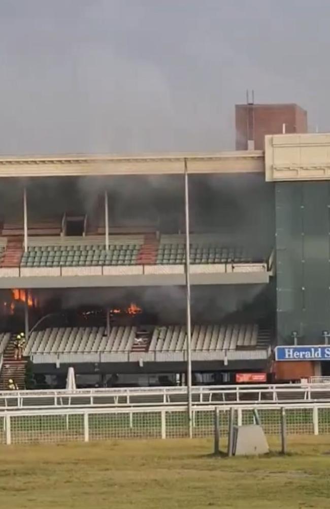 Fire engulfs the grandstand at Caulfield.