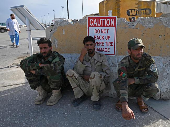 Afghan National Army (ANA) soldiers sit inside the Bagram US air base after all US and NATO troops left, some 70 Kms north of Kabul on July 5, 2021. (Photo by WAKIL KOHSAR / AFP)