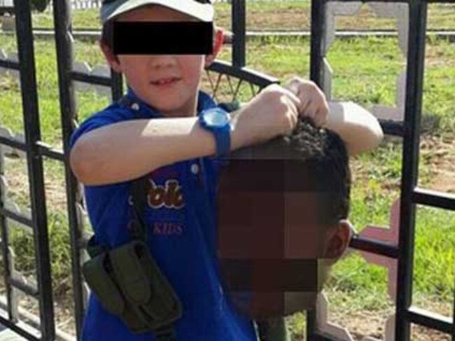 A boy security agencies believe to be Australian Khaled Sharrouf’s son holds the decapitated head of a soldier in the Syrian city of Raqqa. It was posted on Twitter.