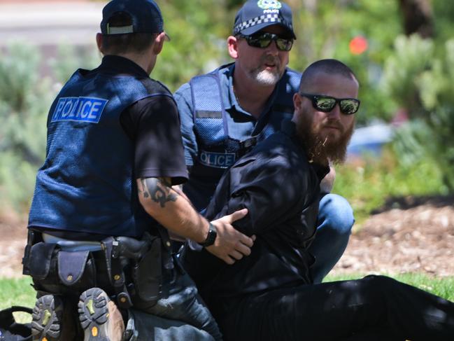 ADELAIDE, AUSTRALIA - JANUARY 26: Member of the National Socialist Network (NSN) is being arrested during a counter protest on North Terrace and East Terrace on January 26, 2025 in Adelaide, Australia. Australia Day, formerly known as Foundation Day, is the official national day of Australia and is celebrated annually on January 26 to commemorate the arrival of the First Fleet to Sydney in 1788. Many indigenous Australians refer to the day as 'Invasion Day' and there is a small but growing movement to change the date amid broader debate on the day's significance. (Photo by Tracey Nearmy/Getty Images)