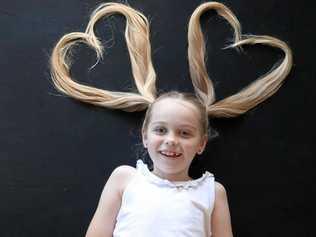 Sienna Sandoz shows off the long locks she will chop off next month to raise money for cancer research.