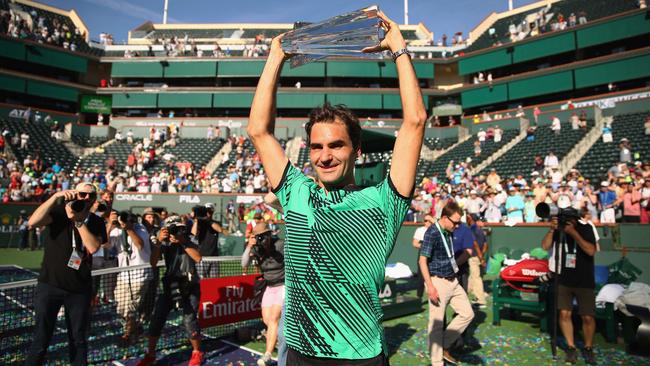 Roger Federer of Switzerland holds the BNP Paribas Open trophy.