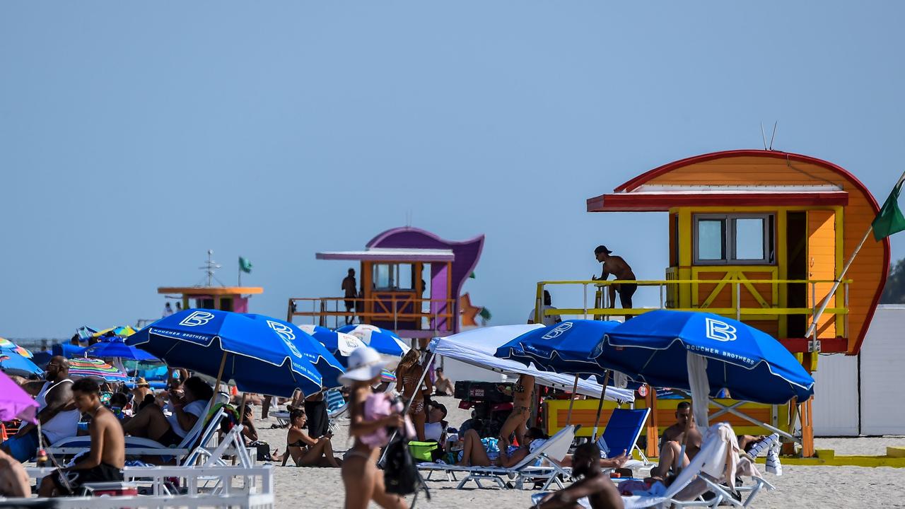 People relax in Miami Beach on July 2, the same day the state reported a record of more than 10,000 new coronavirus cases. Picture: CHANDAN KHANNA / AFP.