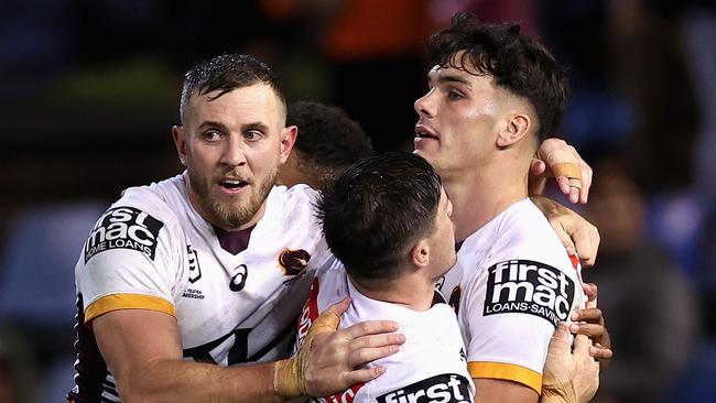 Herbie Farnworth (right) celebrates scoring a try against the Newcastle Knights.