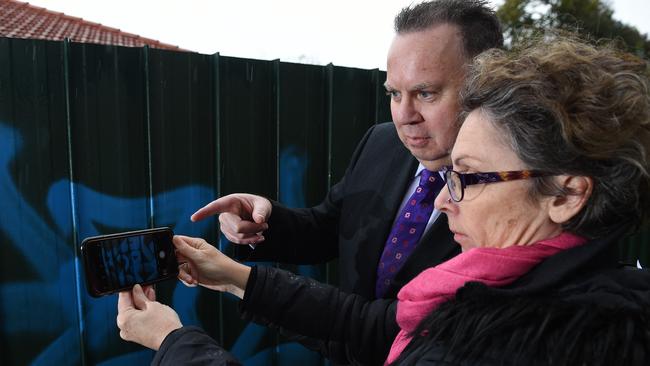 Eastern Region state Labor MP Sonja Terpstra snaps some graffiti on a fence in Croydon with Maroondah Mayor Rob Steane. Picture: Josie Hayden