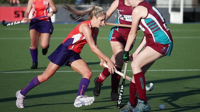 Stingers’ Jess Watson squeezes between two Brothers players in the Cairns Hockey Association A-grade women's match between Cairns Brothers and Trinity Stingers. PICTURE: BRENDAN RADKE