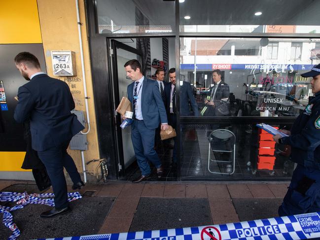 Police leaving the salon on Saturday. Picture: Julian Andrews