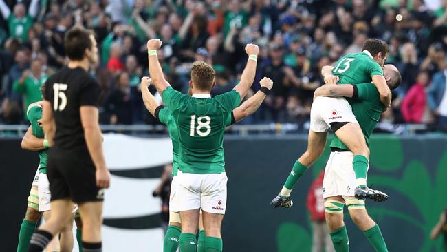 Ireland players celebrate their 40-29 victory over the All Blacks as the final whistle blows.