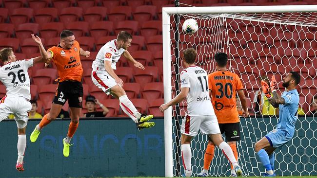 Tom Aldred of the Brisbane Roar, second from left, scores a goal during the round-18 A-League match against Adelaide United at Suncorp Stadium in Brisbane on Saturday. Picture: AAP,