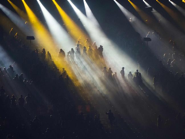 Spectators sit on the stands during a light show of the closing ceremony of the 2018 Gold Coast Commonwealth Games at the Carrara Stadium on the Gold Coast on April 15, 2018. Picture: AFP PHOTO / YE AUNG THU