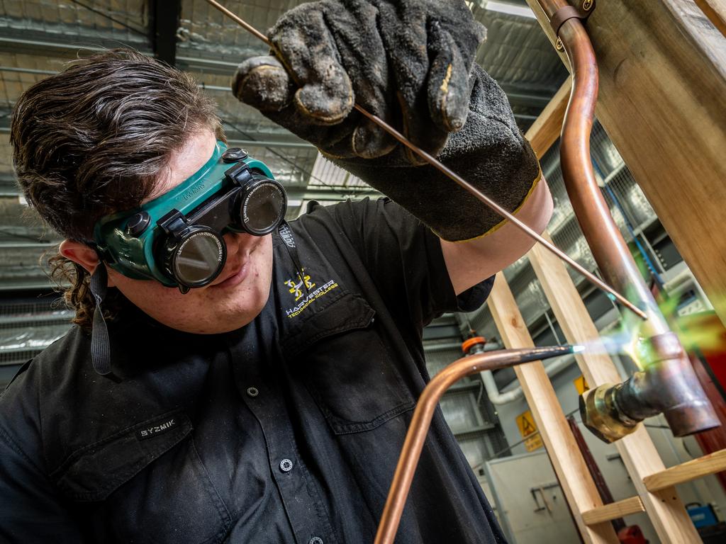 Year 12 student Harvey solders a copper pipe. Picture: Jake Nowakowski