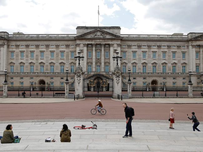 People sit on the steps opposite Buckingham Palace in London Picture: AFP