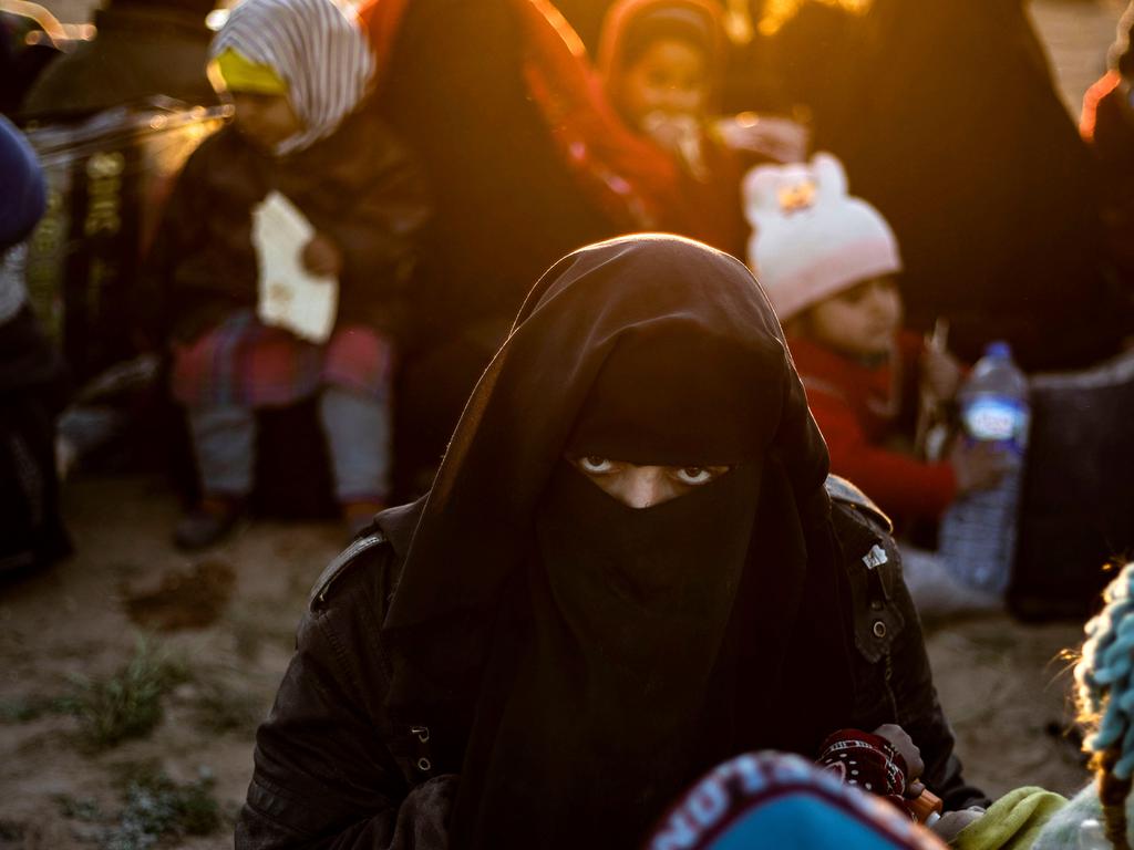 A woman waits to be searched by members of the Kurdish-led Syrian Democratic Forces after leaving the ISIS group's last holdout of Baghouz, in eastern Syria. Picture: AFP