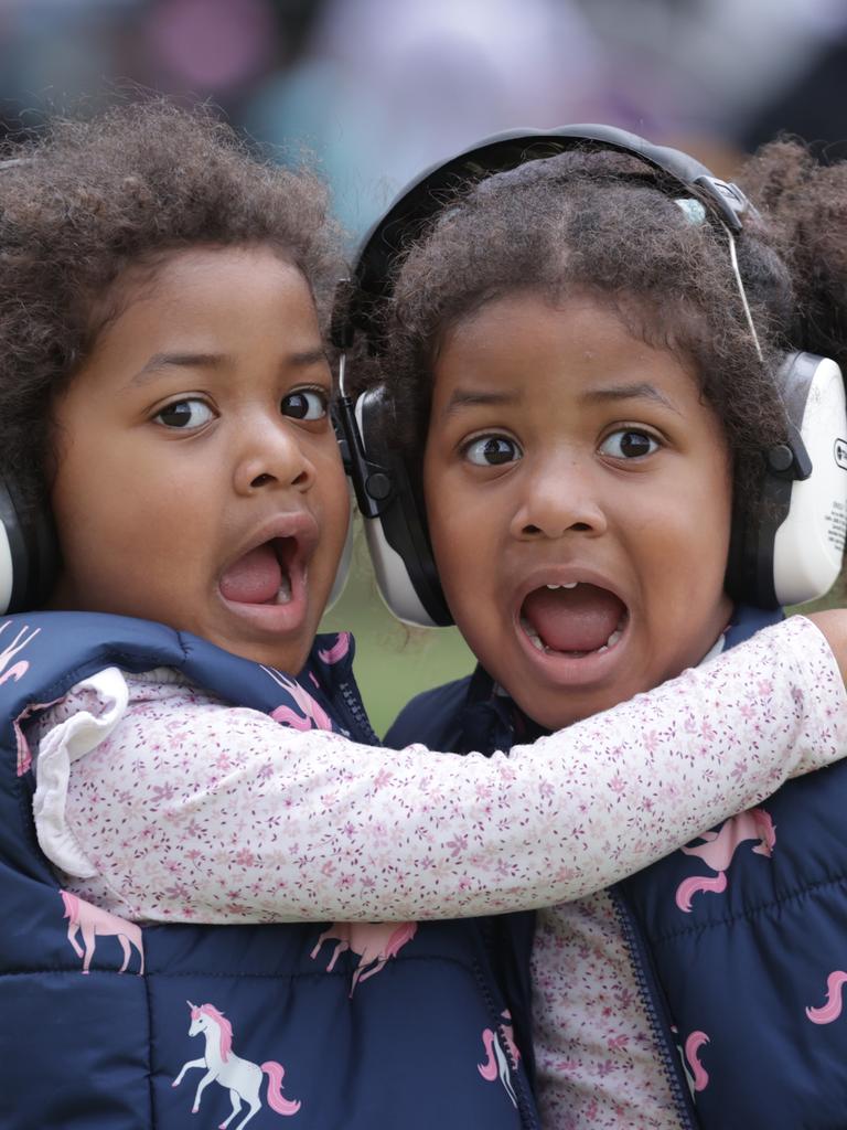 Twin sisters Atiena and Amari Likukuma 3, keeping the noise of the race cars out of the ears. Picture: David Caird